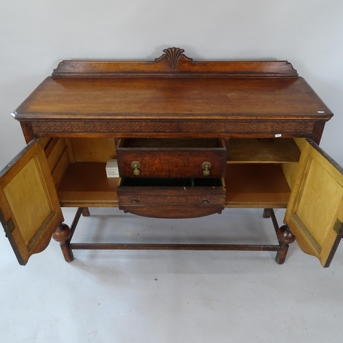 2126 - A 1930s oak sideboard, 138cm x 107cm x 47cm