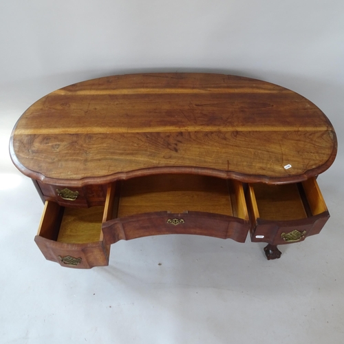 2131 - A reproduction oak kidney-shaped kneehole writing desk, on cabriole legs with claw and ball feet, 13... 