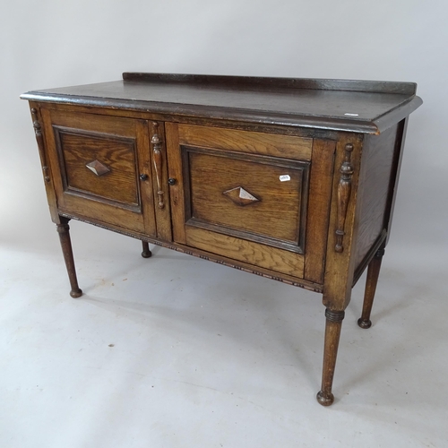 2136 - A 1920s oak sideboard, with raised back and 2 panelled doors, 106cm x 76cm x 44cm