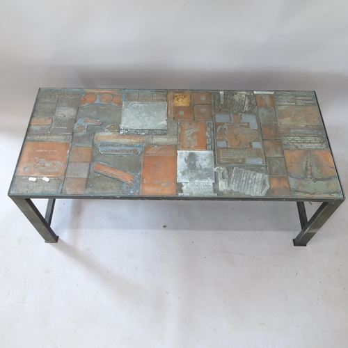 2167 - A contemporary rectangular coffee table, with inset glass top, on metal frame, with inset printing b... 