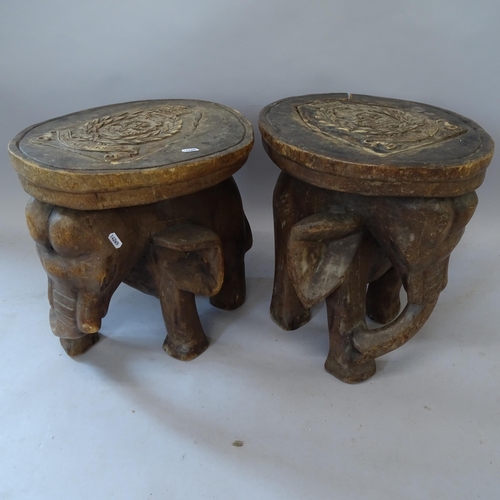 2179 - A pair of similar hardwood carved occasional tables, in the form of elephants, with armorial decorat... 