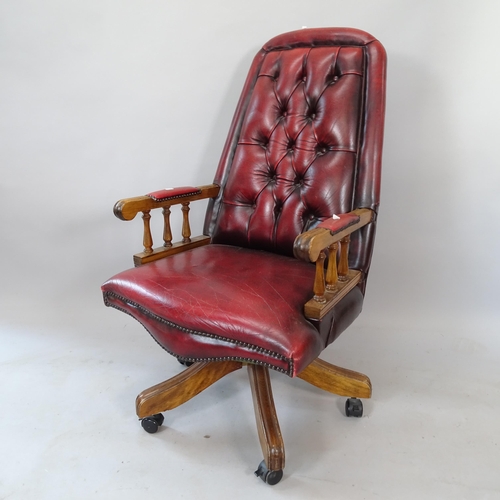 2187 - An early 20th century studded red leather upholstered button-back swivel desk chair