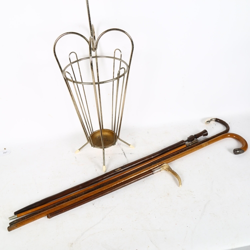 304 - A novelty umbrella stick stand, containing various walking sticks and canes, including Duke of Welli... 