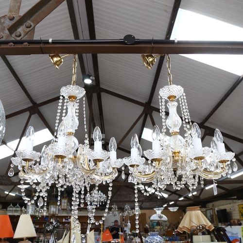 308 - A pair of 8-branch brass and glass chandeliers, with glass drops, height 80cm