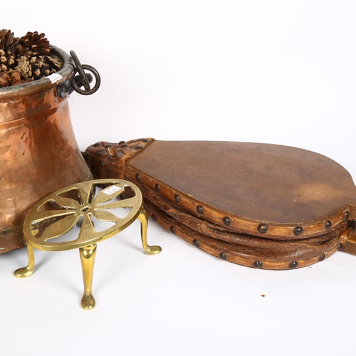 312 - An Antique copper and iron hanging cauldron, pair of bellows, and a brass trivet (3)