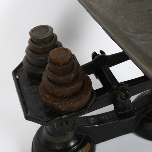 314 - A set of black cast-iron balance scales, with graduated set of weights