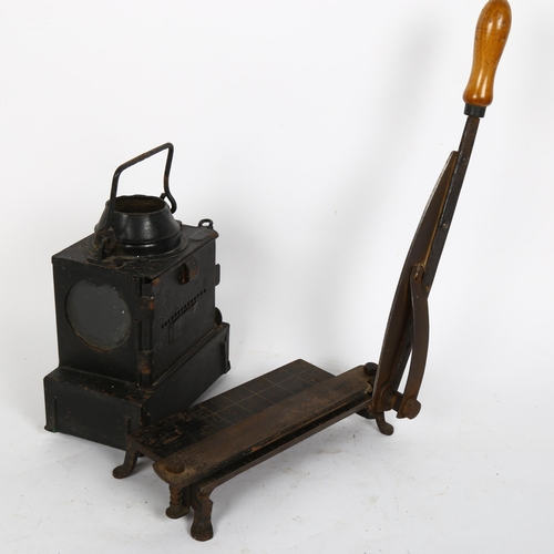 341 - A small black painted metal oil lantern, and a paper guillotine (2)