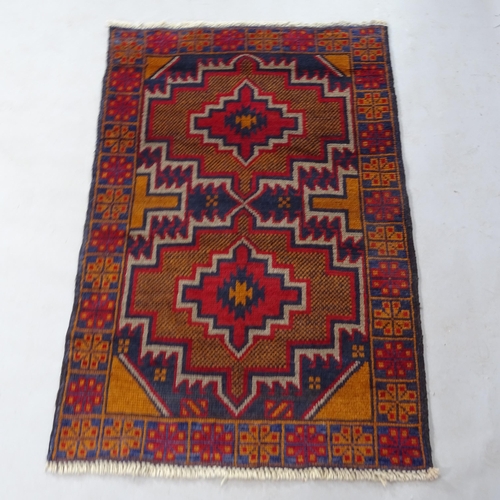 2345 - A red ground Baluchi rug, 137cm x 87cm