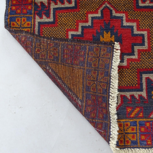 2345 - A red ground Baluchi rug, 137cm x 87cm