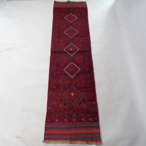 2358 - A red ground Meshwani runner, 253cm x 64cm