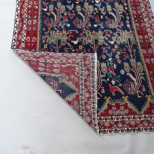 2362 - A red and blue ground Persian rug, 205cm x 148cm