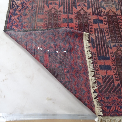 2365 - A red ground Afghan carpet, 295cm x 210cm