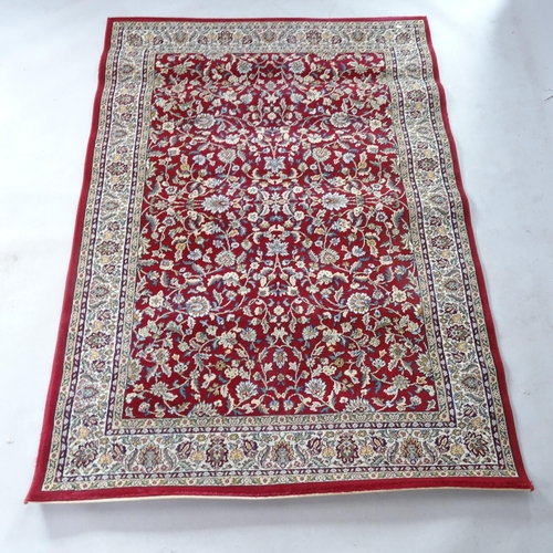 2366 - A modern red ground Turkish rug with floral design, 195cm x 138cm