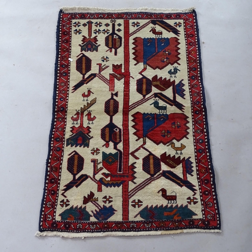 2375 - A small Tribal Iranian carpet, with figural decoration, 130cm x 80cm