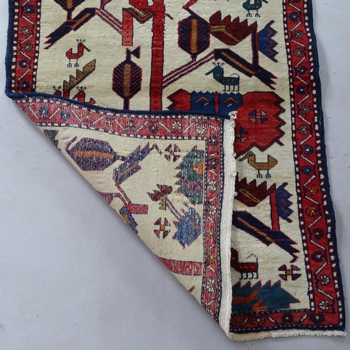 2375 - A small Tribal Iranian carpet, with figural decoration, 130cm x 80cm