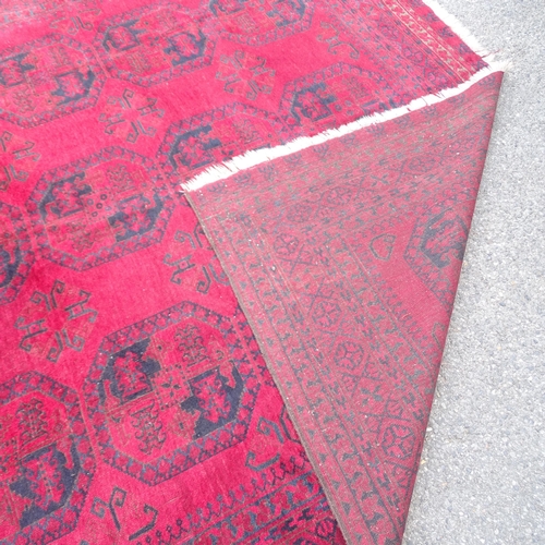 2378 - A red ground Afghan carpet, 331cm x 260cm