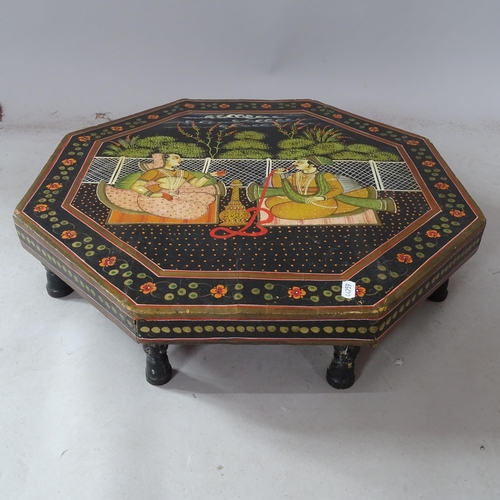 2389 - A black lacquered Indian low octagonal table, with painted decoration, 53cm x 13cm