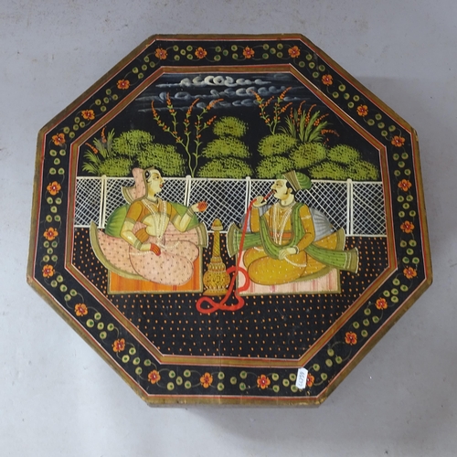 2389 - A black lacquered Indian low octagonal table, with painted decoration, 53cm x 13cm