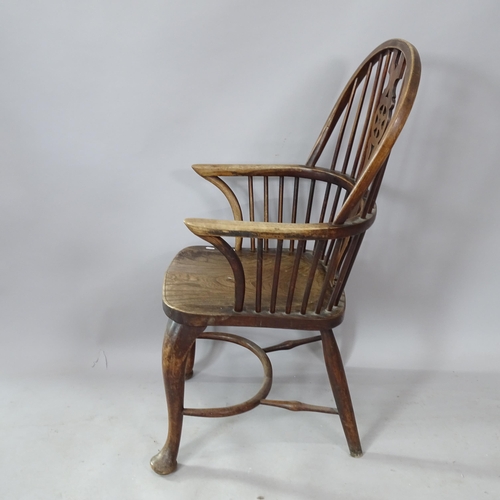 2250 - An oak and elm-seated wheel-back kitchen chair, with crinoline stretcher