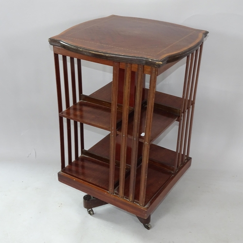 2253 - An Edwardian mahogany crossbanded and satinwood-strung revolving bookcase, 52cm x 84cm