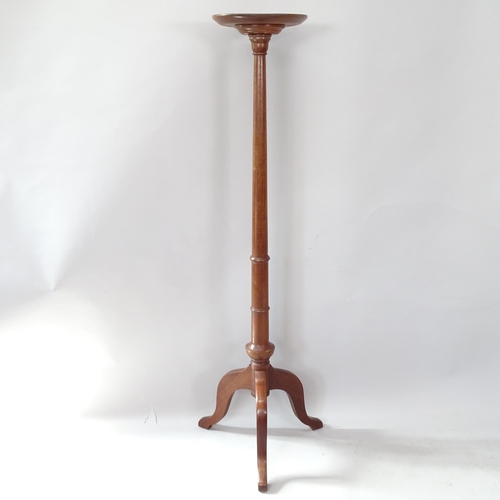 2265 - A reproduction mahogany torchere on tripod base, 143cm