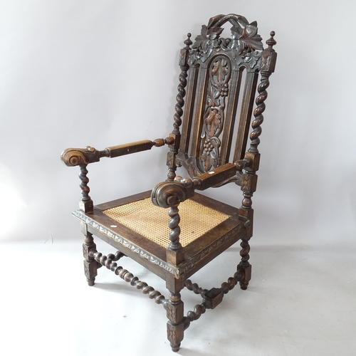 2266 - A Victorian carved oak throne chair, with cane seat, barley twist supports and carved decoration