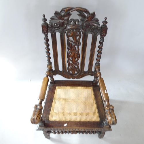 2266 - A Victorian carved oak throne chair, with cane seat, barley twist supports and carved decoration