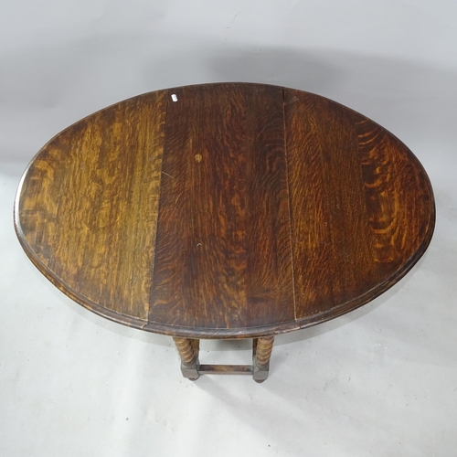 2302 - An Antique oak oval gateleg table, with barley twist columns, 77cm x 72cm x 36cm