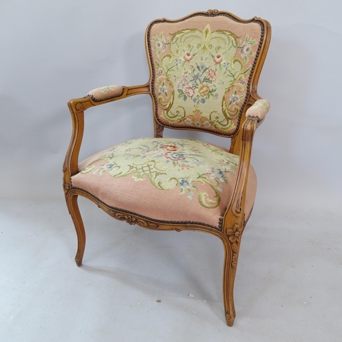 2335 - A Continental yew wood tapestry upholstered open armchair, with carved decoration