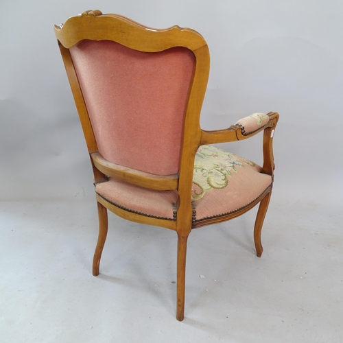 2335 - A Continental yew wood tapestry upholstered open armchair, with carved decoration