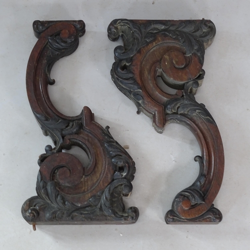 2338 - A pair of antique carved oak furniture mounts, 52cm