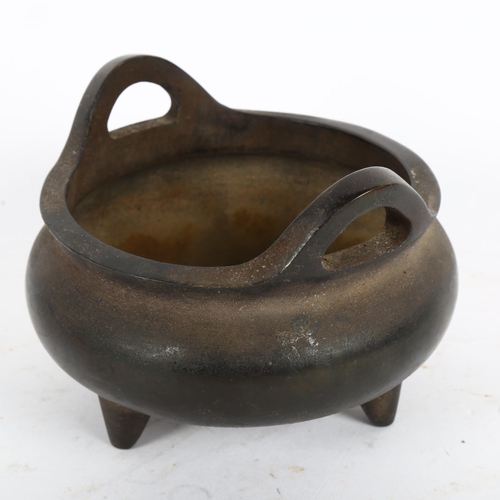 433 - A Chinese bronze tripod incense burner, character mark on base, diameter 12cm