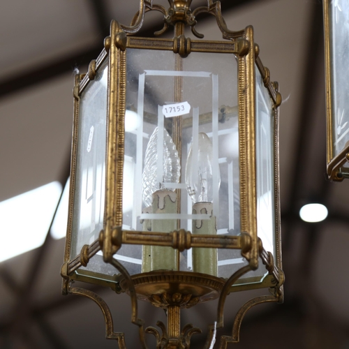 438 - 2 brass-framed glass ceiling lanterns, largest height 60cm