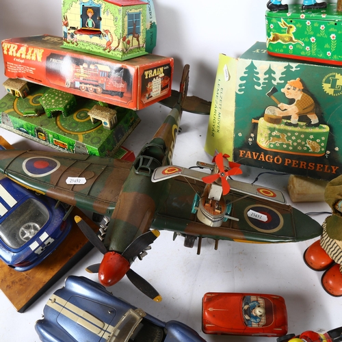 486 - A quantity of Vintage and reproduction tin toys, including a Spitfire aeroplane