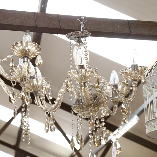 502 - A pair of modern glass and chrome 5-branch chandeliers (A/F), height 60cm approx