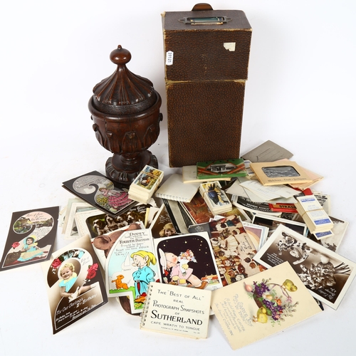 511 - A group of Vintage postcards, and carved wood urn and cover