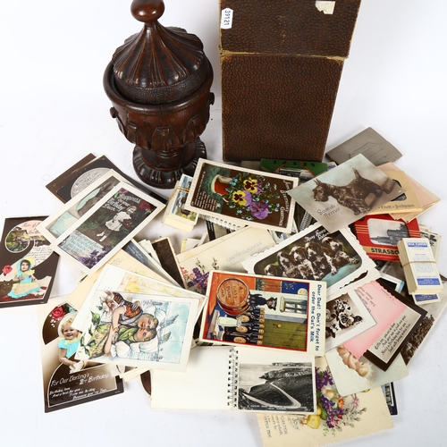 511 - A group of Vintage postcards, and carved wood urn and cover