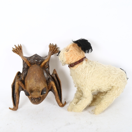 512 - An early 20th century straw-filled dog, and an unusual pottery study of a bat