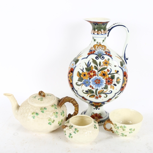 519 - A hand painted Delft ewer, height 30cm, and a Belleek third mark teapot, sugar bowl and single tea c... 