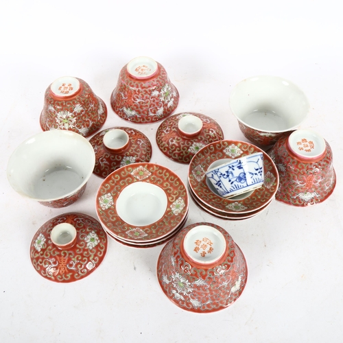 520 - A group of Chinese red enamelled tea bowls and stands, and a blue and white tea bowl