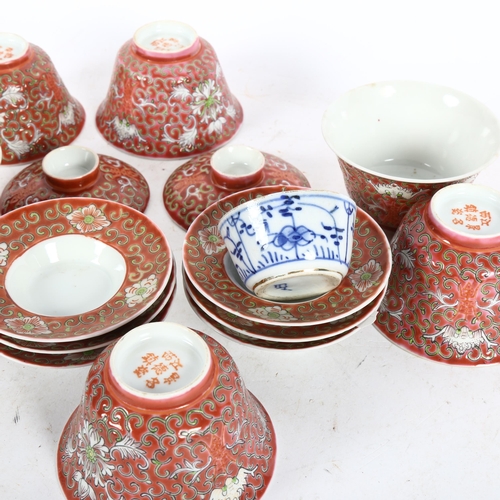 520 - A group of Chinese red enamelled tea bowls and stands, and a blue and white tea bowl