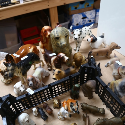 530 - A large quantity of ceramic and metal dog ornaments, including Beswick, Wade Whimsies, Tremar etc