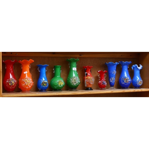 763 - A shelf of colourful 1950s glass vases with applied floral decoration, tallest 25cm