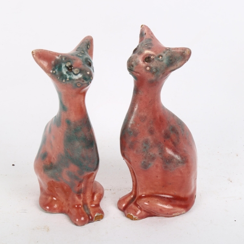 794 - A pair of Brannam William Baron Barnstaple pottery seated cats, signed, marked 133, height 11cm