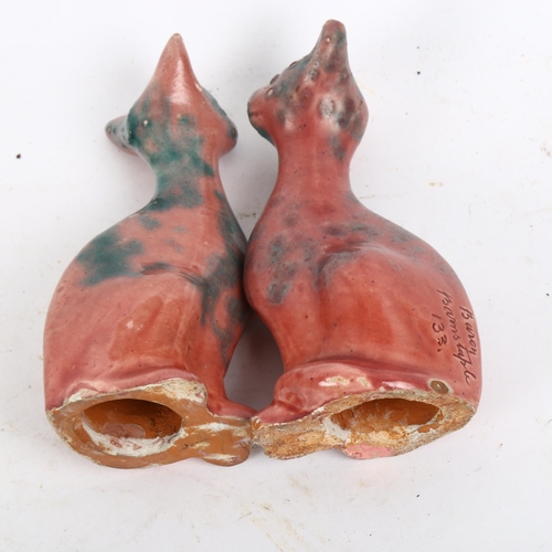 794 - A pair of Brannam William Baron Barnstaple pottery seated cats, signed, marked 133, height 11cm