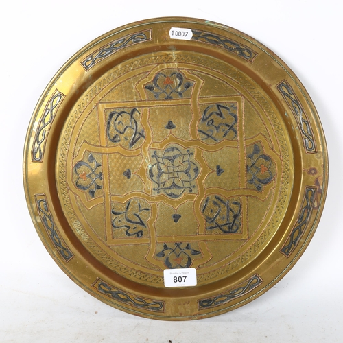 807 - A Turkish brass charger, with silvered and brass embossed decoration, width 35cm