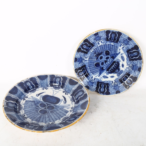 808 - A graduated pair of 18th century Dutch Delft peacock pattern chargers, both marked, diameters 31cm a... 