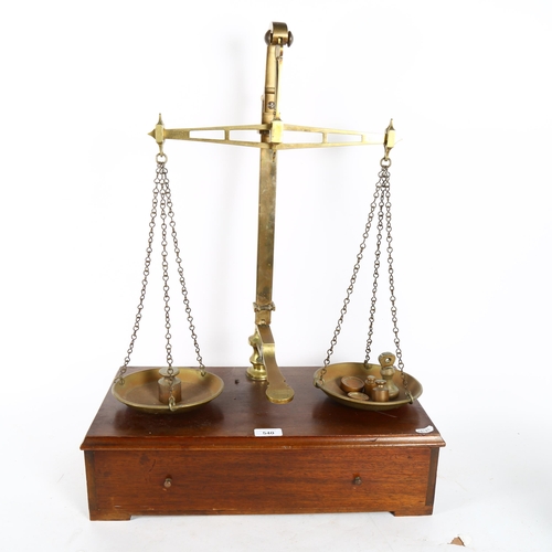 540 - W & T AVERY LTD - an early 20th century brass balance scales and weights, on a drawer-fitted stand, ... 