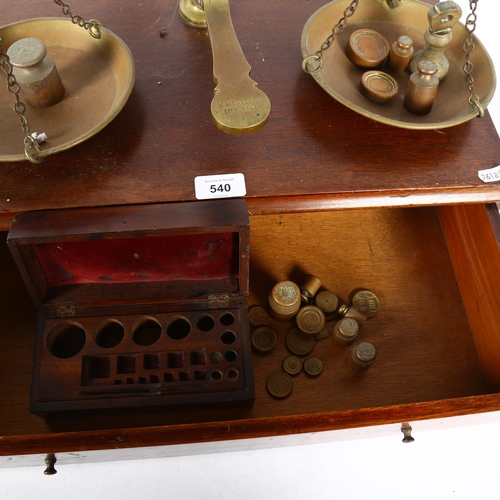 540 - W & T AVERY LTD - an early 20th century brass balance scales and weights, on a drawer-fitted stand, ... 