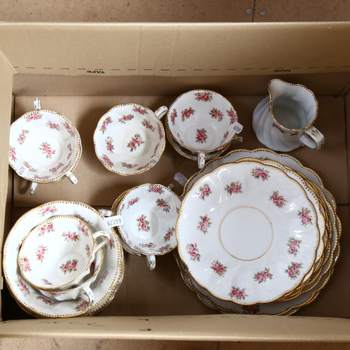 551 - A ceramic tea set for 10 people, white ground decorated with flowers (pattern 227?)